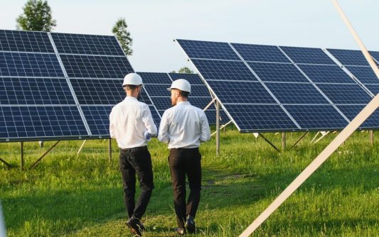 engineer and businessman planing new ecology project. around solar panel roof.